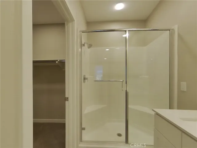 a bathroom with a glass shower door