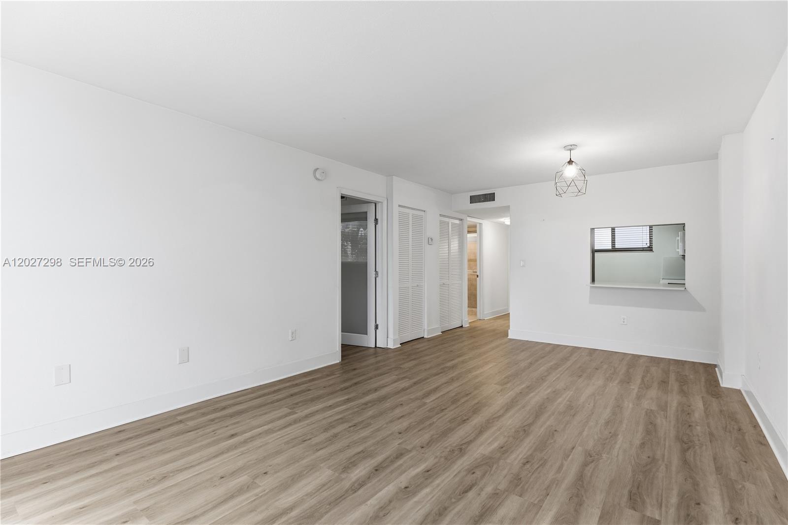 1665 Bay Road, Unit 322 Miami Beach, FL 33139 - Photo 6 of 24 a view of empty room with wooden floor