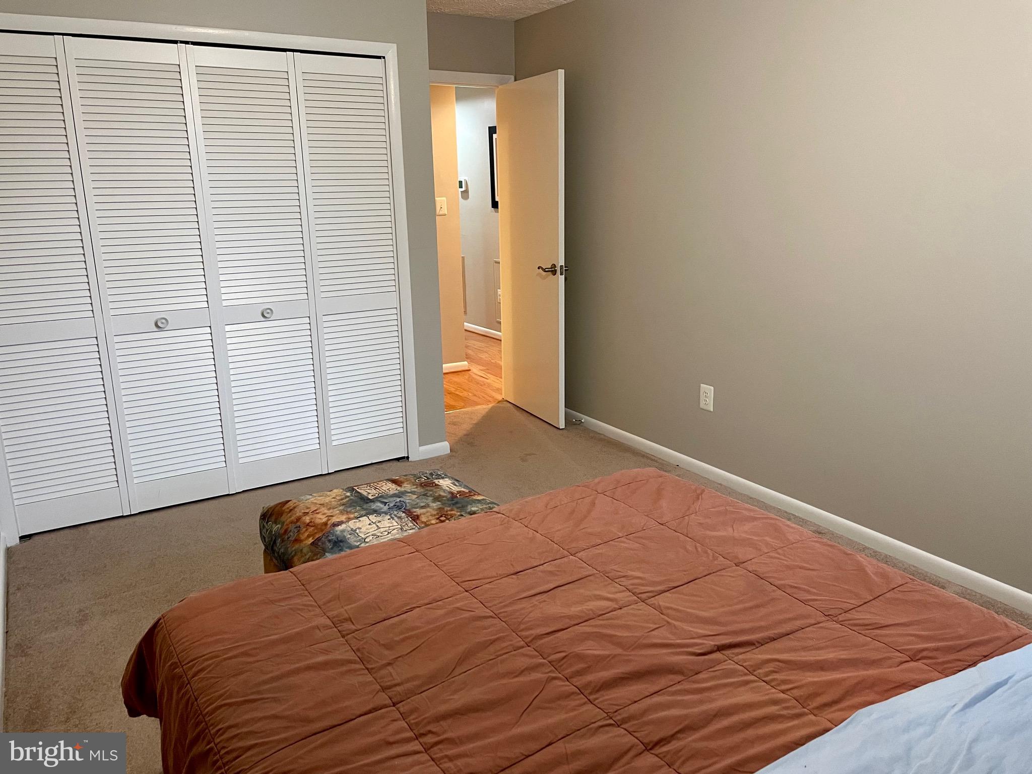 7 A Friendswood Court, Unit 7A Baltimore, MD 21209 - Photo 23 of 32 a bedroom with a bed and hallway