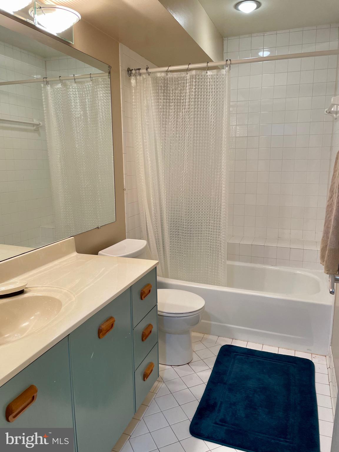 7 A Friendswood Court, Unit 7A Baltimore, MD 21209 - Photo 25 of 32 a bathroom with a sink a toilet and shower