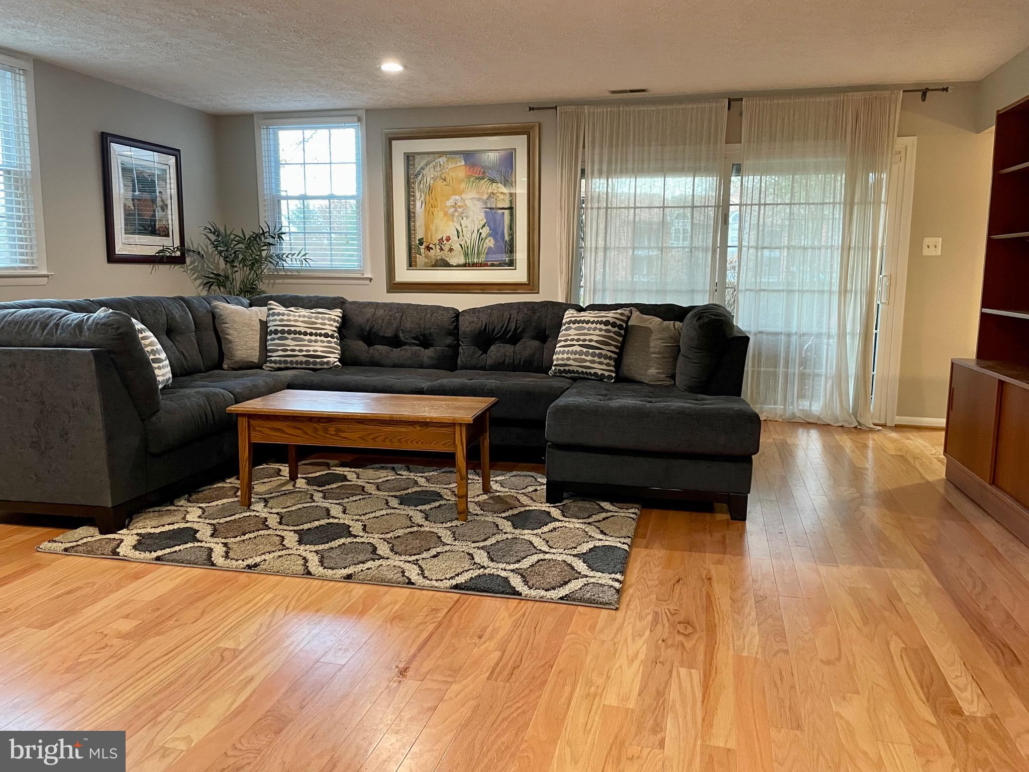 7 A Friendswood Court, Unit 7A Baltimore, MD 21209 - Photo 7 of 32 a living room with furniture and a flat screen tv