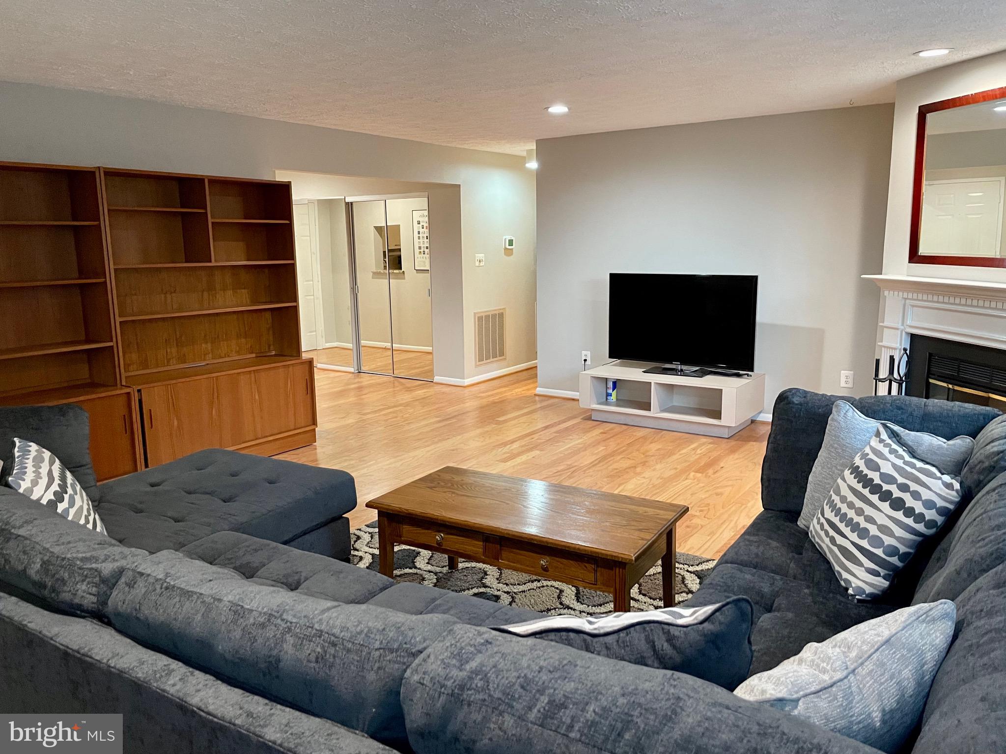 7 A Friendswood Court, Unit 7A Baltimore, MD 21209 - Photo 10 of 32 a living room with furniture and a flat screen tv