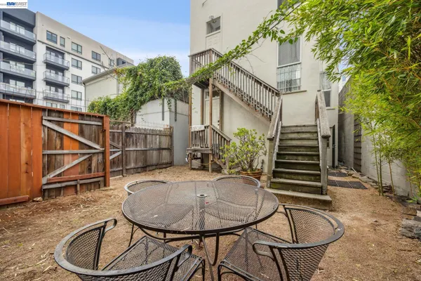 a backyard of a house with table and chairs