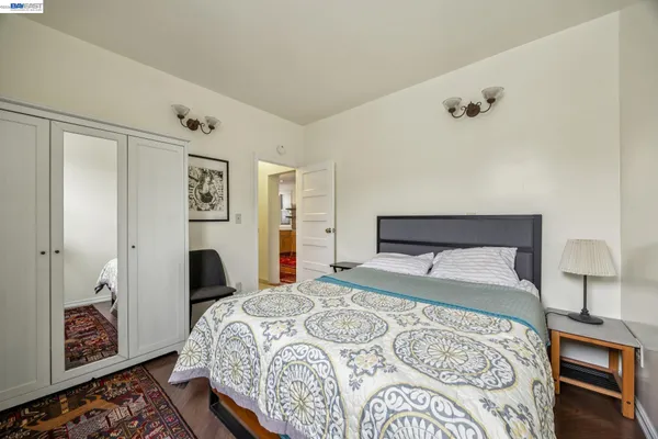a bedroom with a large bed and a chandelier