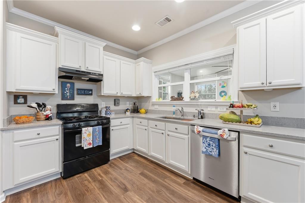36 Birch River Court Dallas, GA 30132 - Photo 12 of 49 a kitchen with granite countertop white cabinets and appliances