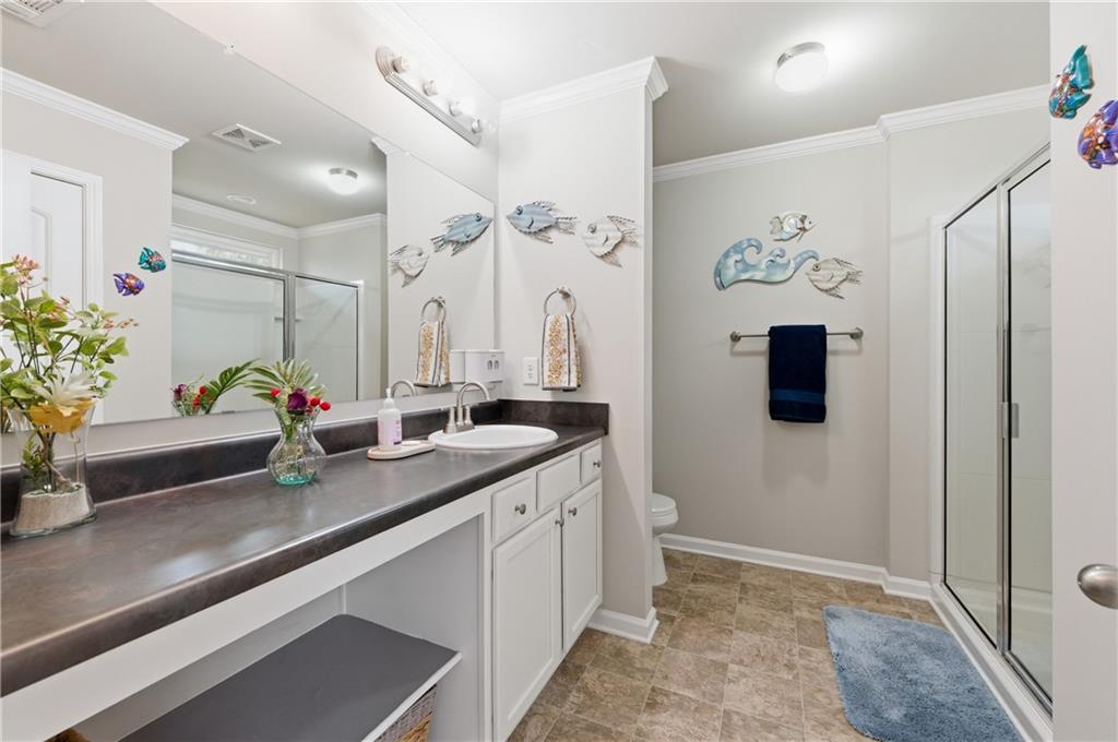 36 Birch River Court Dallas, GA 30132 - Photo 24 of 49 a bathroom with a sink a mirror and a shower