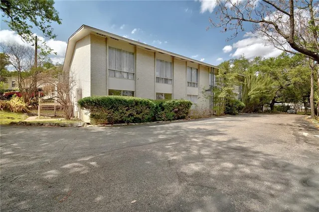 a view of a park with large trees