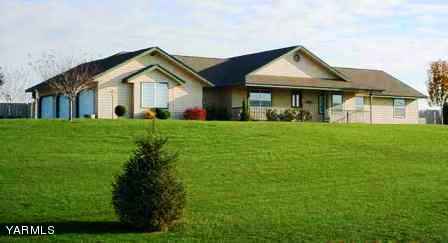 1600 Division Road Zillah, WA 98953 - Photo 4 of 4 a front view of a house with a yard and trees