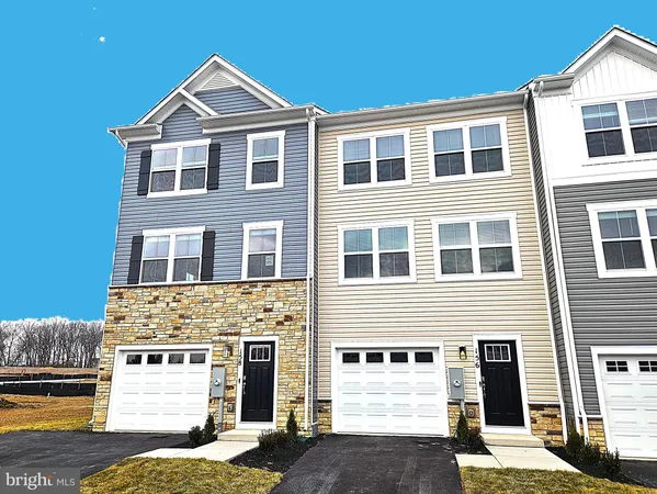 a front view of a house with a parking space
