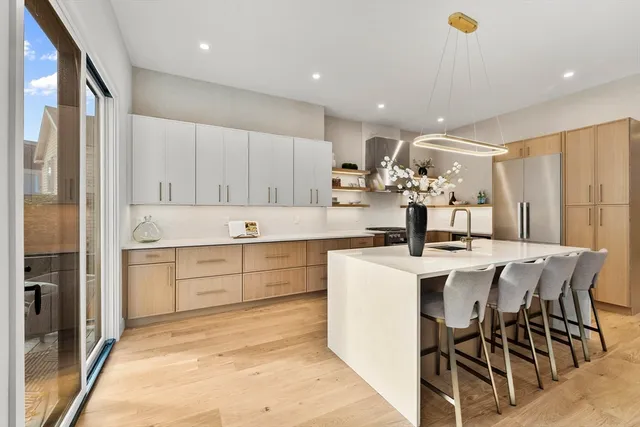 a kitchen with white cabinets and stainless steel appliances