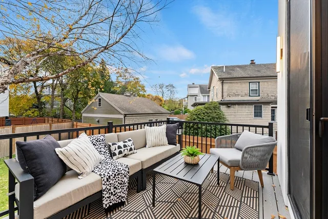 a view of balcony with seating space and wooden floor