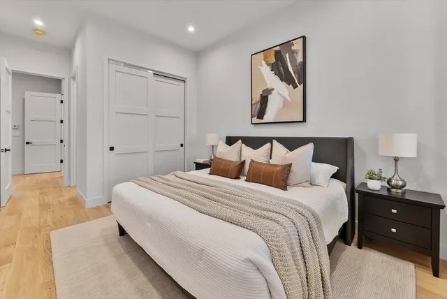 a bedroom with a bed and a lamp