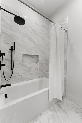 a bathroom with a bath tub and a shower