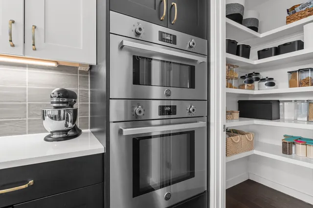a kitchen with cabinets and steel stainless steel appliances