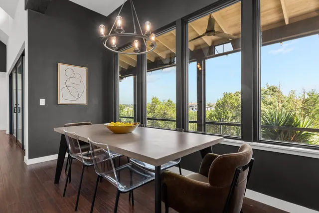 a view of a dining room with furniture a chandelier and wooden floor