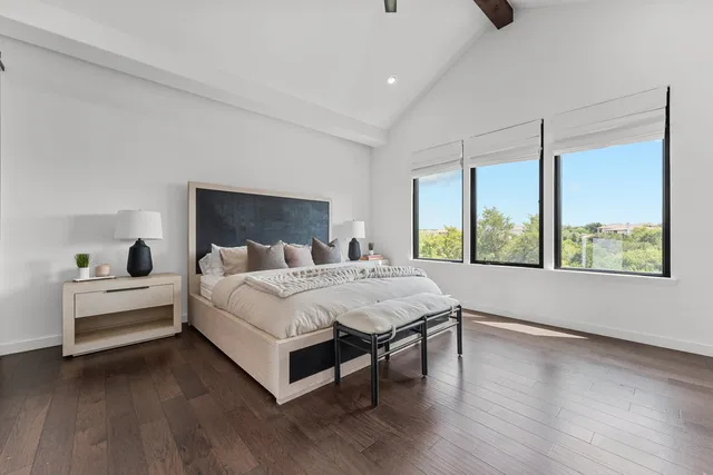 a bed room with a bed and a large window