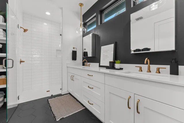 a bathroom with a double vanity sink and a mirror