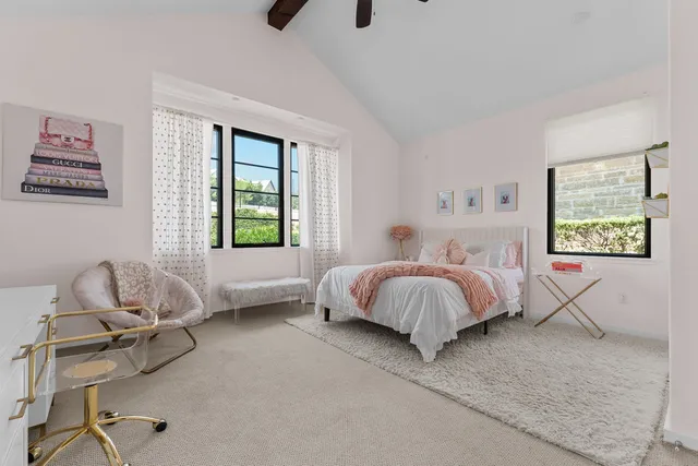 a spacious bedroom with a bed and a window