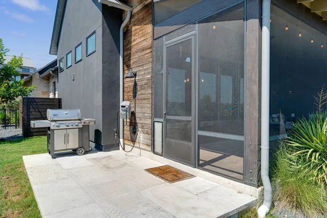 a backyard of a house with table and chairs