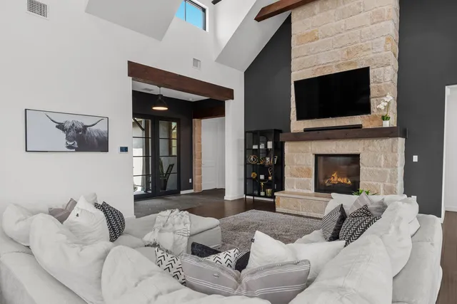 a living room with furniture fireplace and flat screen tv