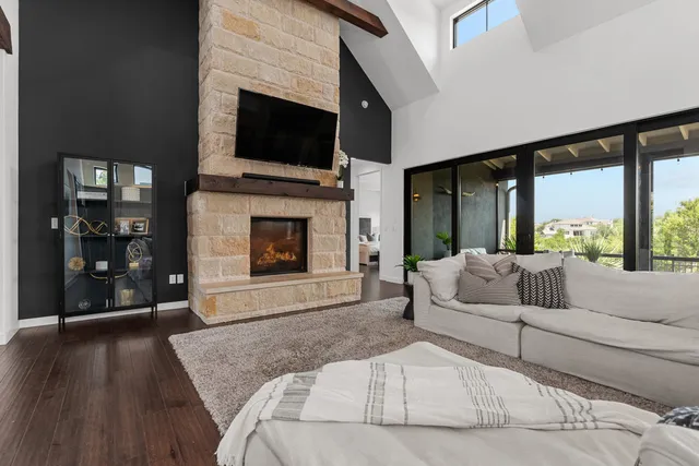 a living room with furniture fireplace and flat screen tv