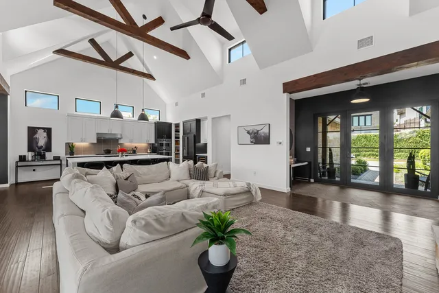 a living room with furniture and a chandelier