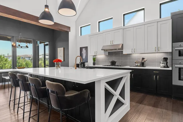 a kitchen with a table chairs sink and cabinets