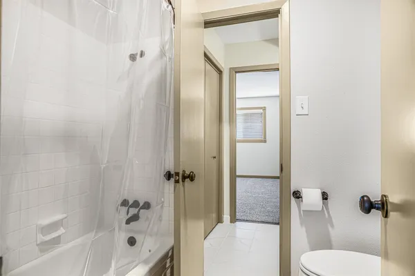 a bathroom with a toilet and a bathtub