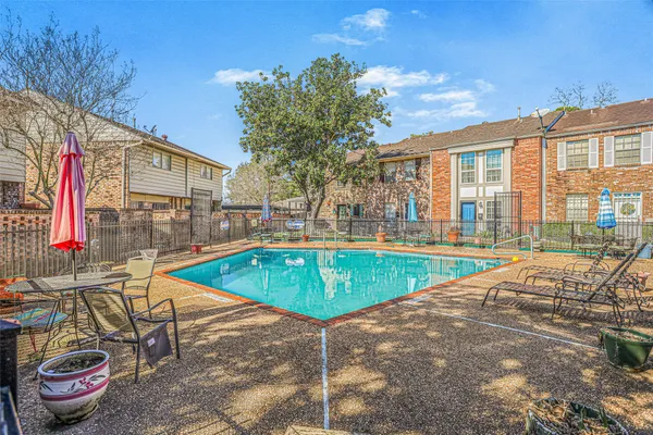 a view of a swimming pool with a lounge chairs