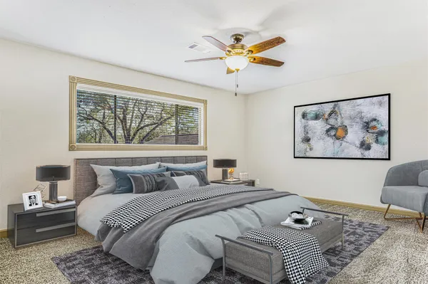 a bedroom with a bed and a painting on the wall