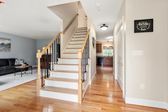 a view of a hallway view with wooden floor and staircase