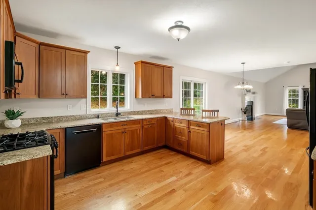 a large kitchen with kitchen island granite countertop a sink counter space and stainless steel appliances