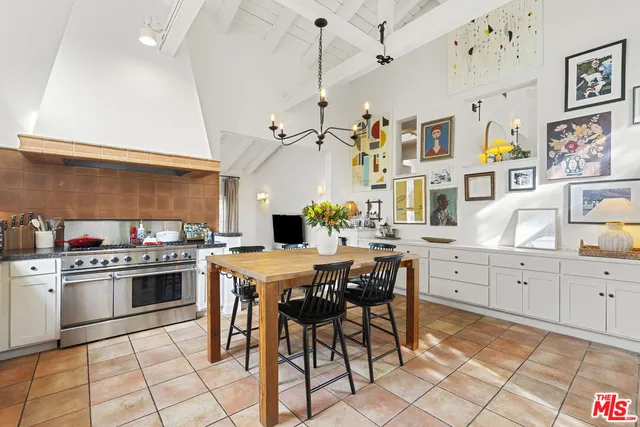 a kitchen with stainless steel appliances a stove a sink dishwasher and white cabinets with wooden floor