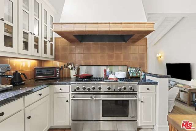 a kitchen with stainless steel appliances a stove and a microwave