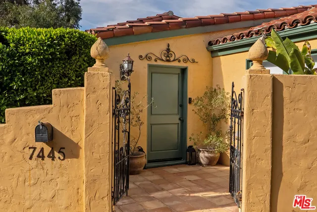 a view of a house with a wooden fence