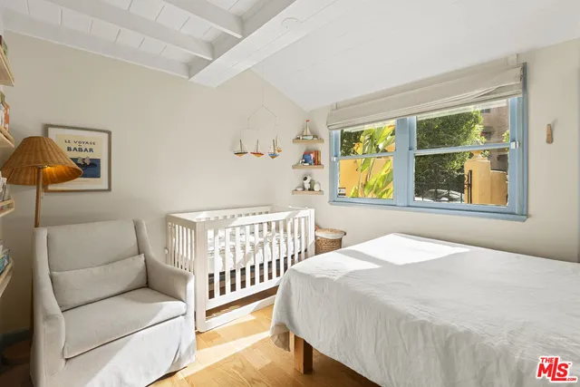 a bedroom with a bed and a window with outer view