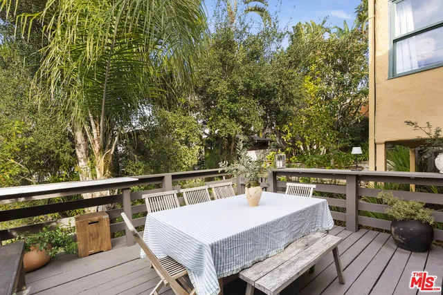 a view of a balcony with wooden floor and outdoor seating