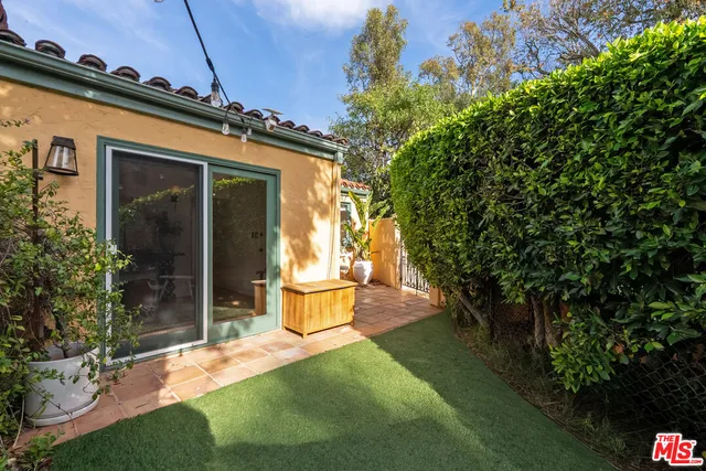 a view of a house with backyard and sitting area