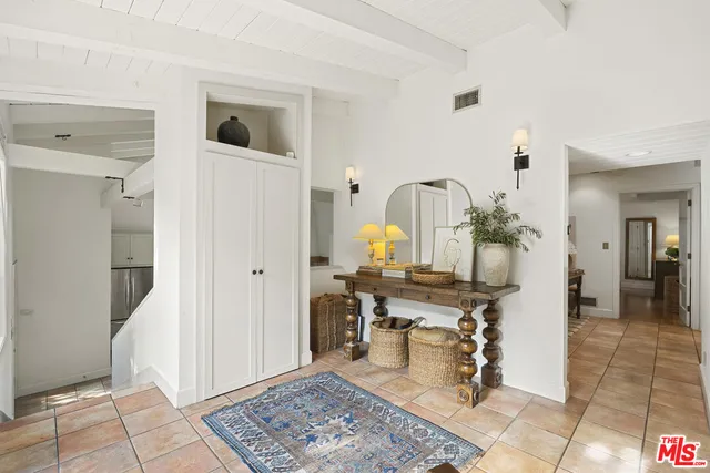 a view of a hallway with dining room and wooden floor