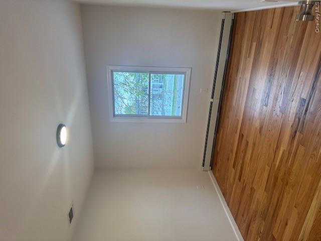 24 Moriches Road Lake Grove, NY 11755 - Photo 18 of 31 a view of a room with wooden floor and window