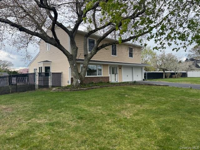 24 Moriches Road Lake Grove, NY 11755 - Photo 2 of 31 a view of a yard in front of a house with large trees