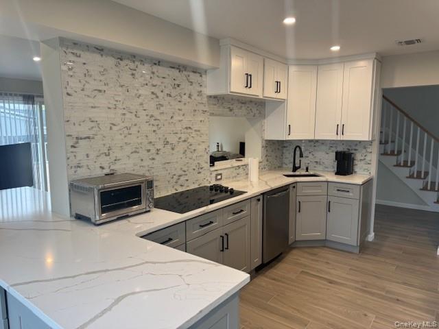 24 Moriches Road Lake Grove, NY 11755 - Photo 3 of 31 a kitchen with sink cabinets and wooden floor