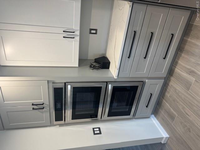 24 Moriches Road Lake Grove, NY 11755 - Photo 4 of 31 a kitchen with granite countertop white cabinets stainless steel appliances and a sink