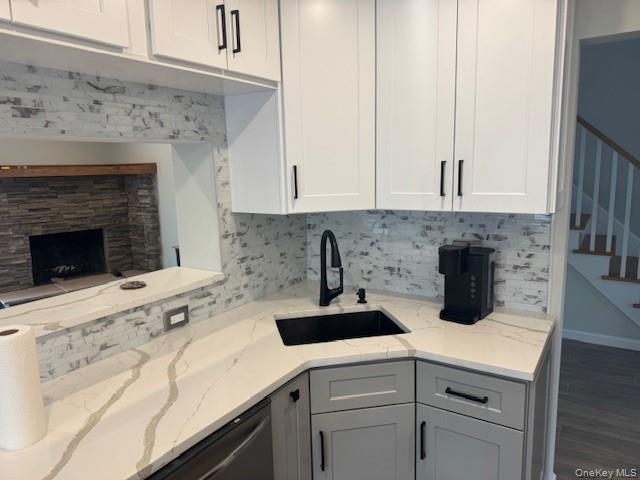 24 Moriches Road Lake Grove, NY 11755 - Photo 5 of 31 a kitchen with a sink stove and cabinets