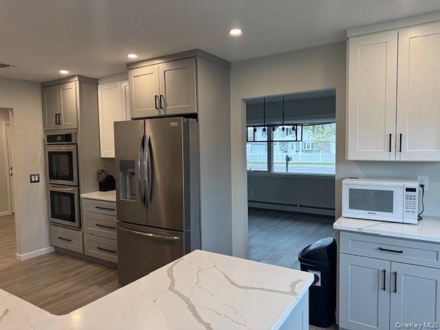 24 Moriches Road Lake Grove, NY 11755 - Photo 6 of 31 a kitchen with a refrigerator and a stove