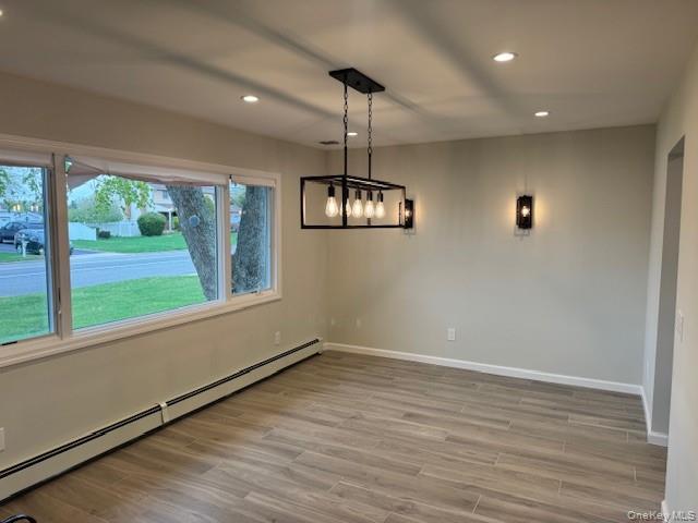 24 Moriches Road Lake Grove, NY 11755 - Photo 8 of 31 a view of an empty room with wooden floor and a window