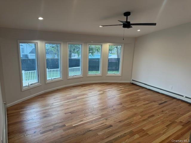 24 Moriches Road Lake Grove, NY 11755 - Photo 9 of 31 a view of an empty room with wooden floor and a window