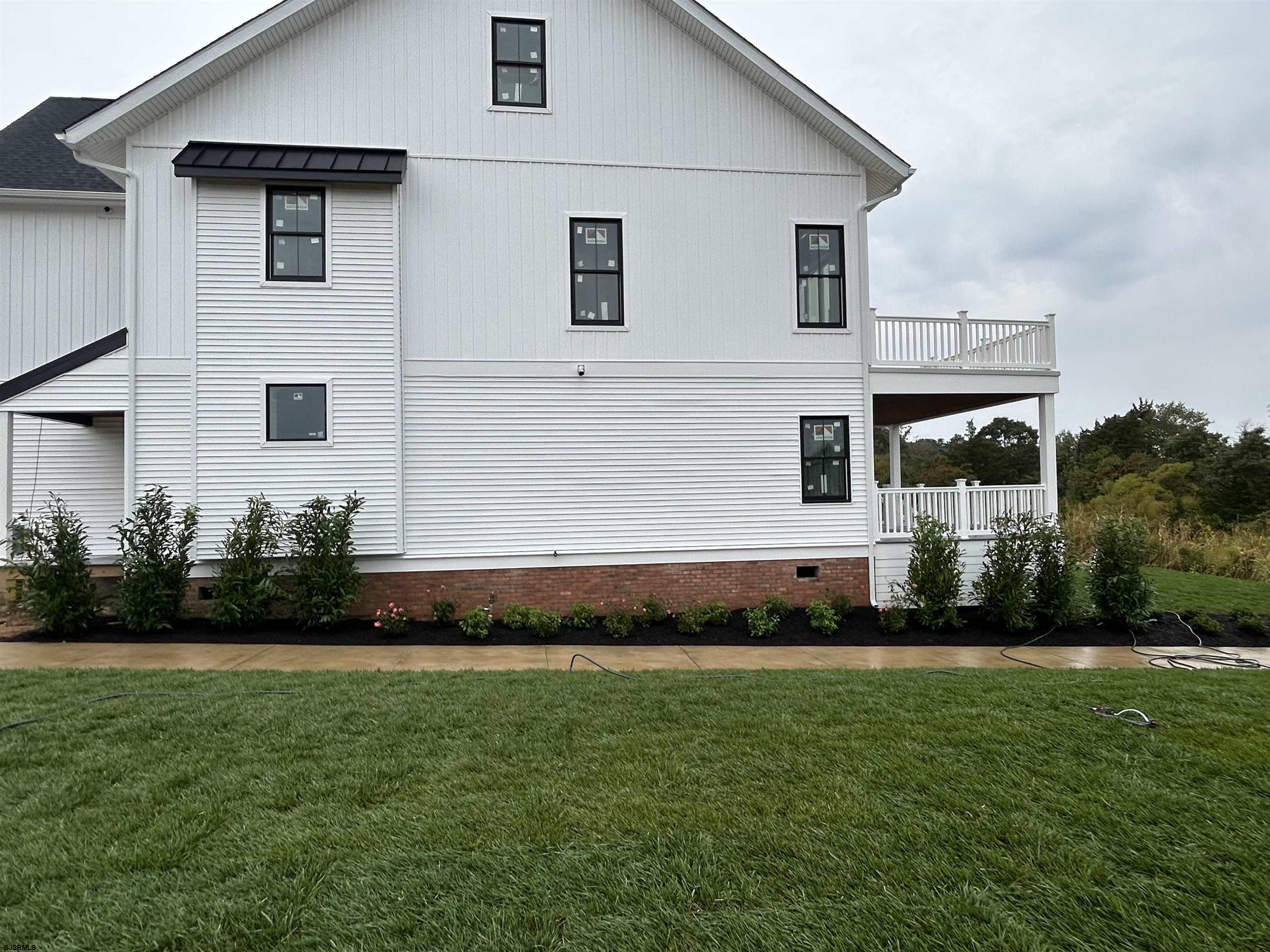 16 Creek Lane Linwood, NJ 08221 - Photo 5 of 26 a front view of a house with a garden and yard