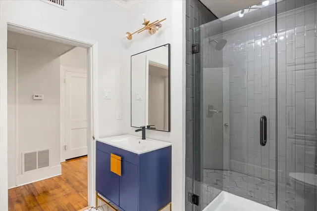 a bathroom with a sink shower and a mirror
