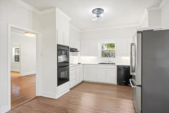 a kitchen with a refrigerator and a stove top oven